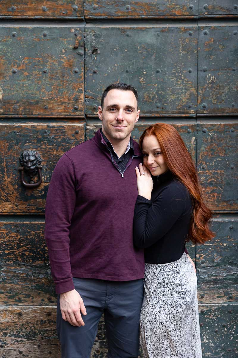 Couple portrait photographed in front of an ancient green doorway 