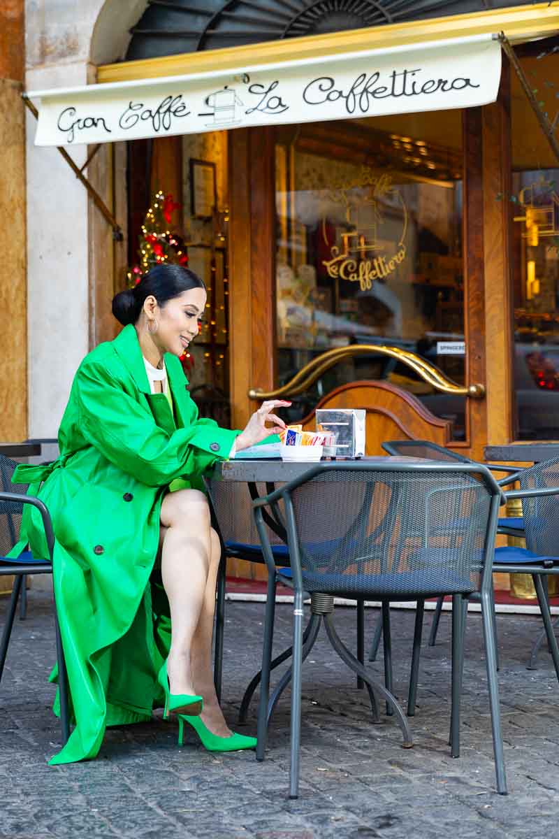 Bright colorful outfit change into gree. Editorial photo session at a caffe in Rome Italy 
