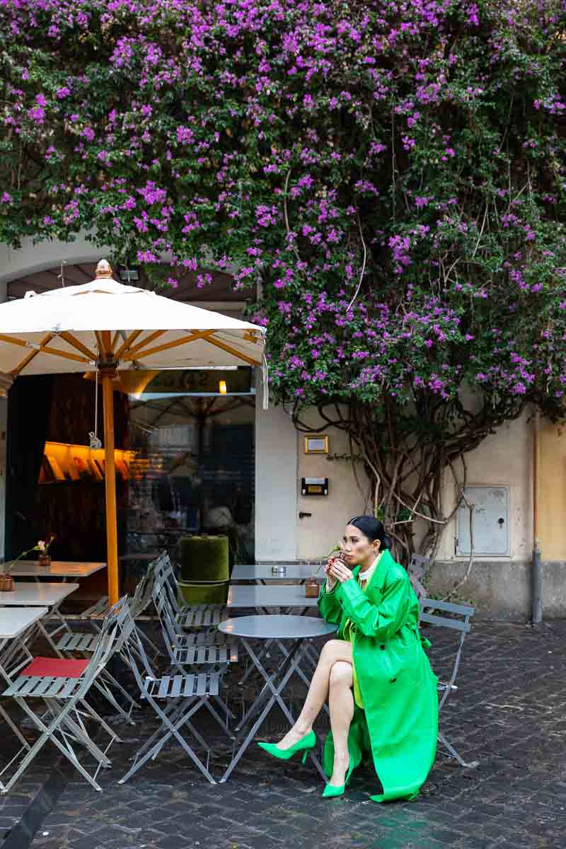 Model sipping tea coffee at a roman bar in Italy during a photoshoot in Rome Italy