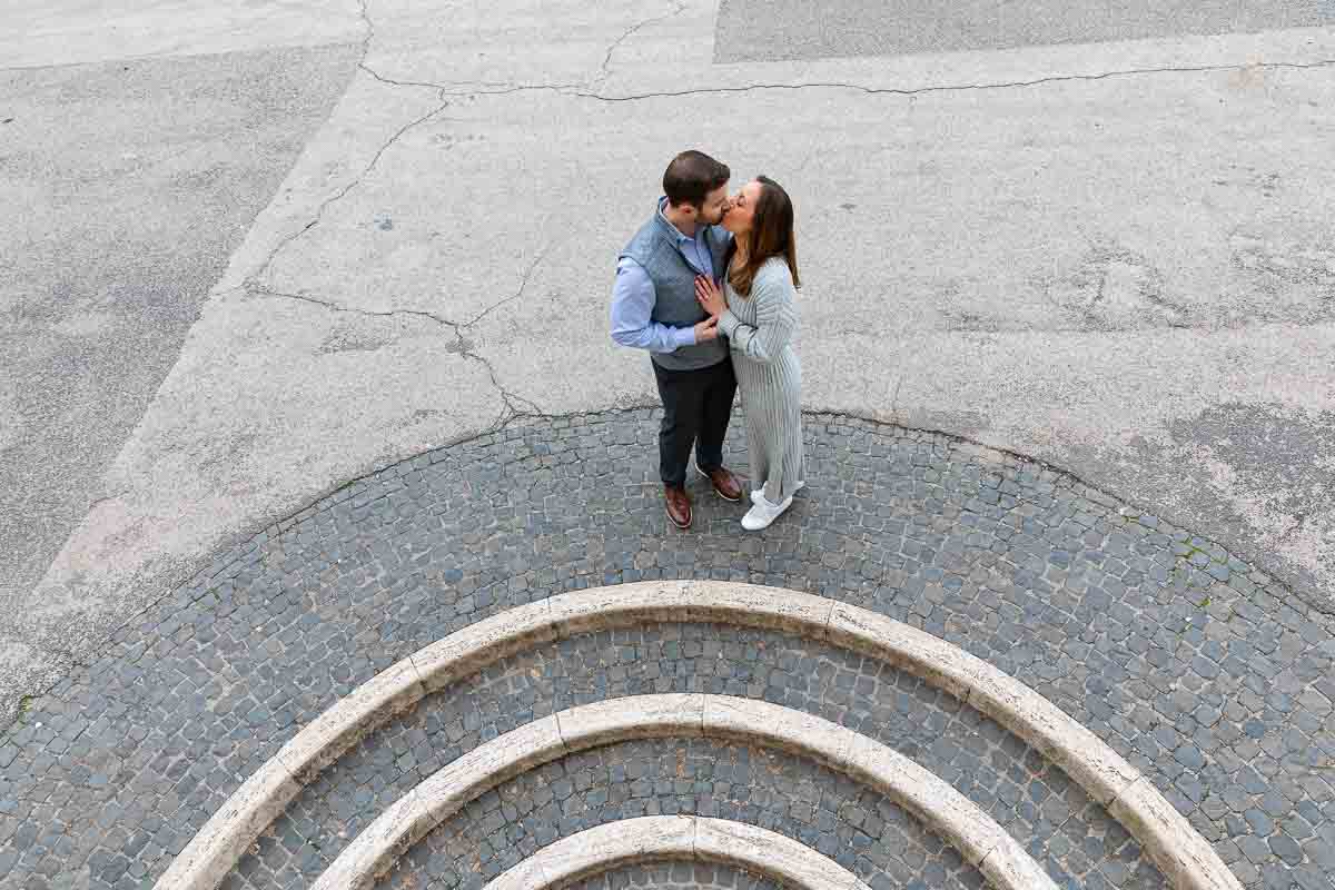 Couple kissing on top of circular geometric steps 