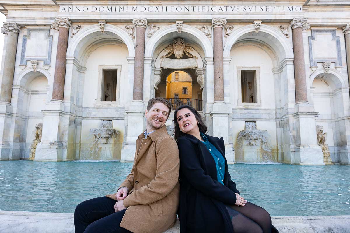 Sitting down and looking at each other n front of the Fontanone water fountain found up on the Janiculum hill in Rome Italy