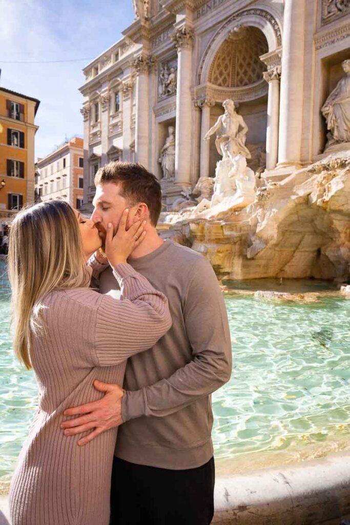 Couple romantically kissing at the Trevi fountain. One of Rome's most scenic location. Image taken during a couple photo shoot