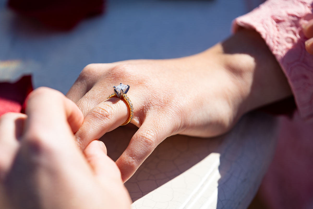 Up close image of the engagement ring photographed on her hand