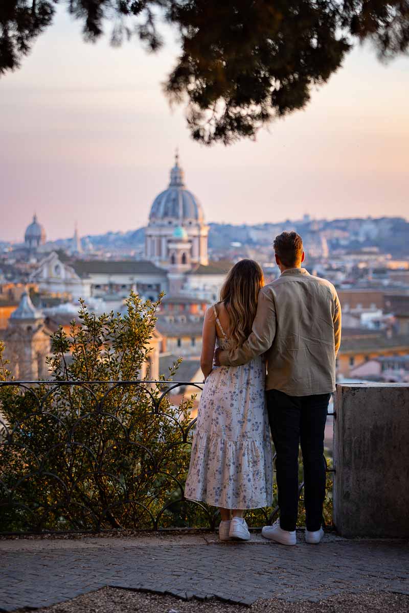 Just engaged. Couple enjoying the while of the Rome cityscape during a photography session 