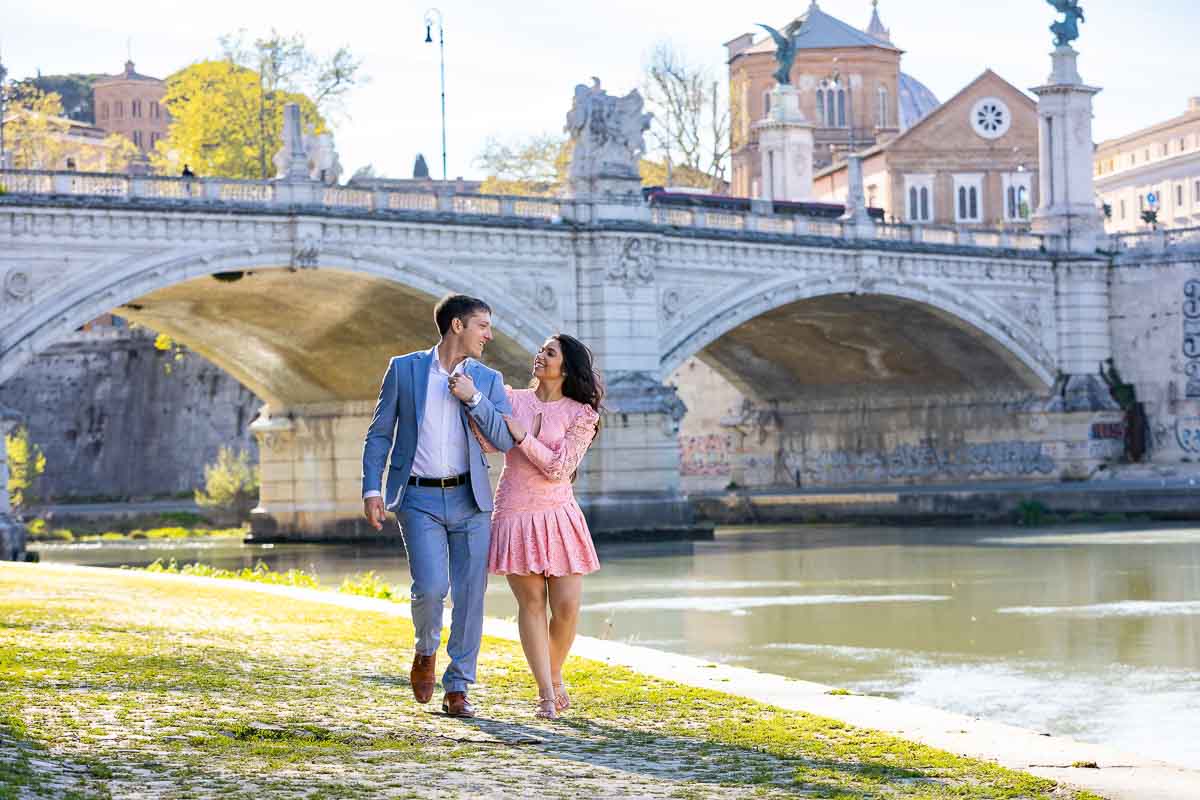 Walking together while taking picture by the Tiber river in Rome 