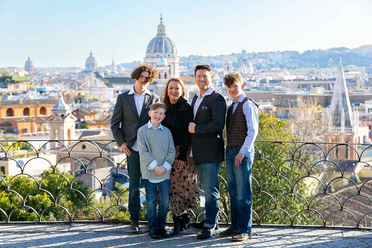 Stand up family portrait picture taken in front of the roman skyline viewed from the Parco del Pincio terrace panoramic outlook 