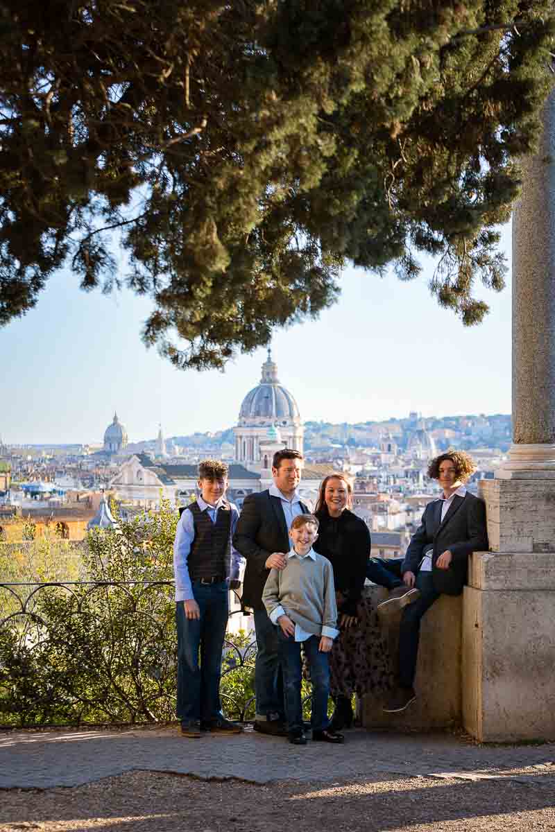 FAmily photo taken in Villa Borghese with the beautiful view of the Rome cityscape 