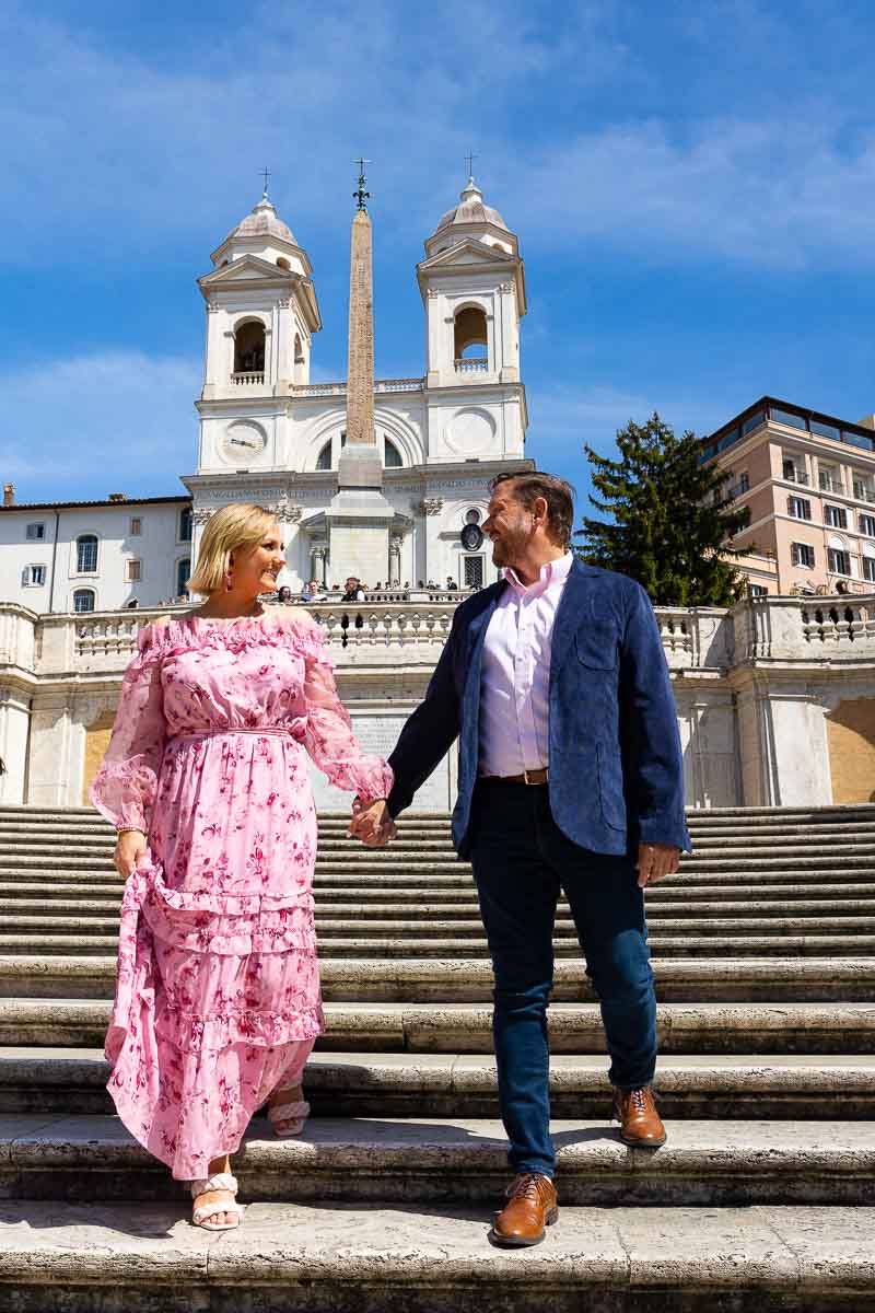 Couple walking down the Spanish steps staircase holding hands while on a photoshoot
