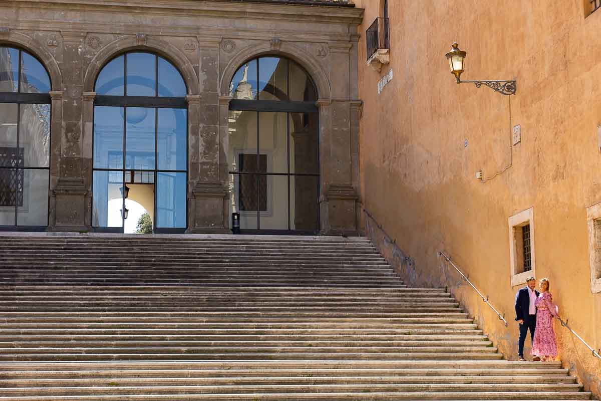 Standing on the Campidoglio stairs under a light post. Wide angle view