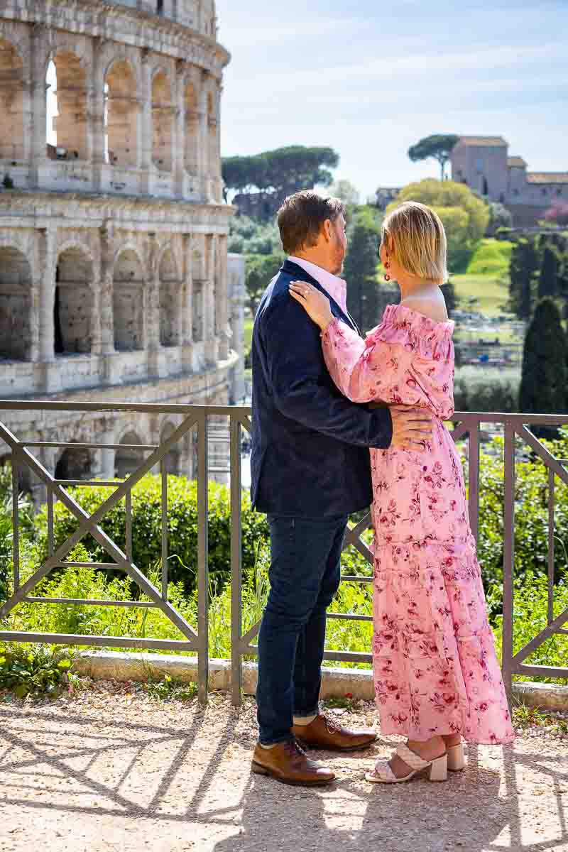 Standing and looking at the Roman Colosseum in the far distance.