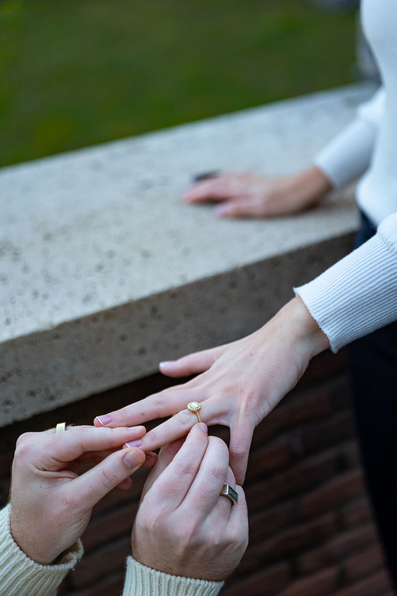 Putting on the engagement ring on the finger during a marriage proposal in Rome