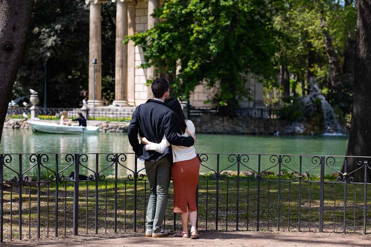 Couple admiring the view of the temple from the other side of the lake 