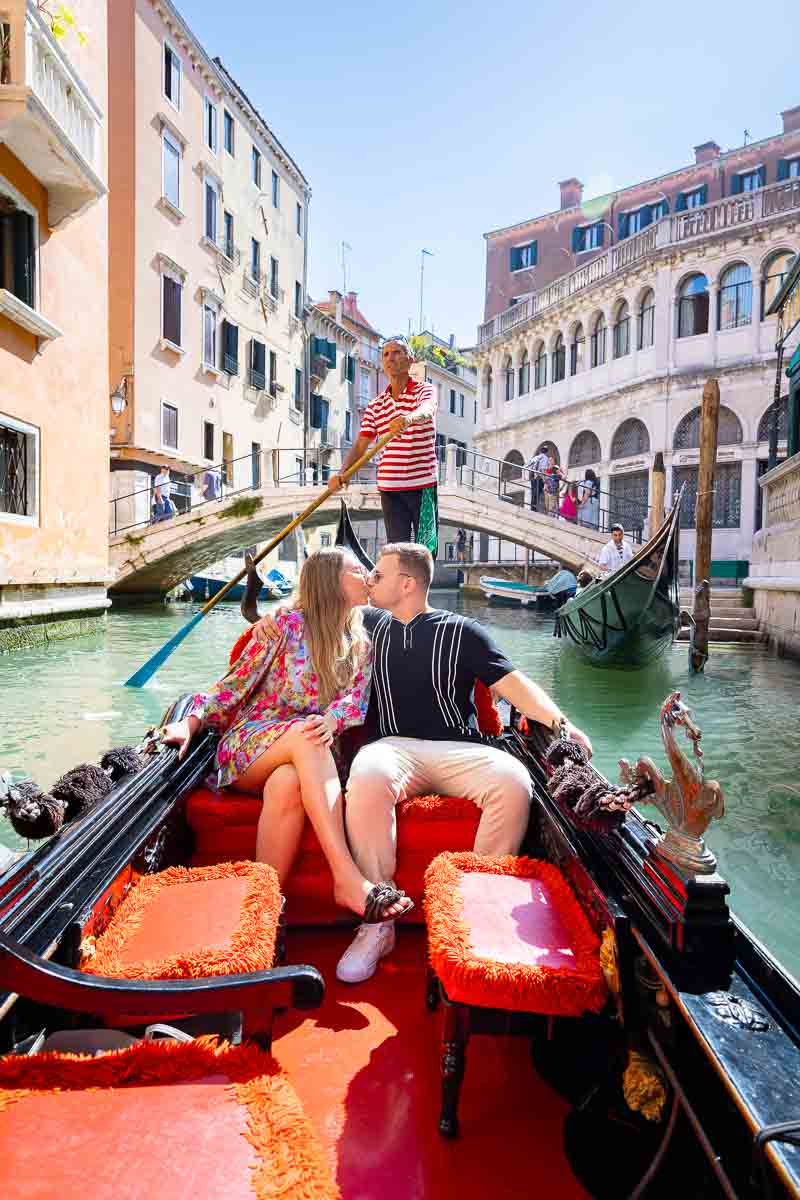 Couple kissing on a Gondola in Venice Italy