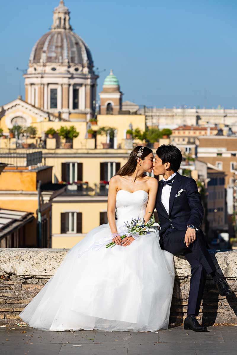 Sitting down on the streets of Rome Italy and finding the most scenic background for wedding photos in Rome