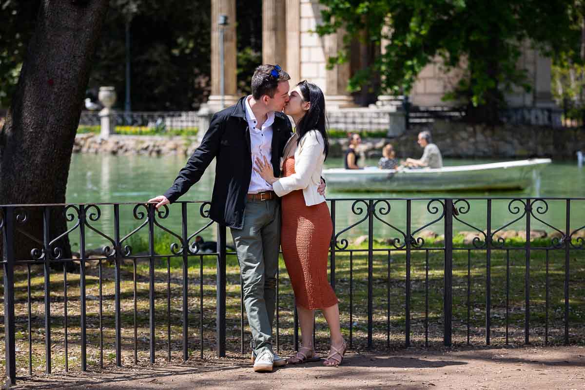 Kissing before the temple during an engagement photoshoot in the Borghese park of Rome Italy