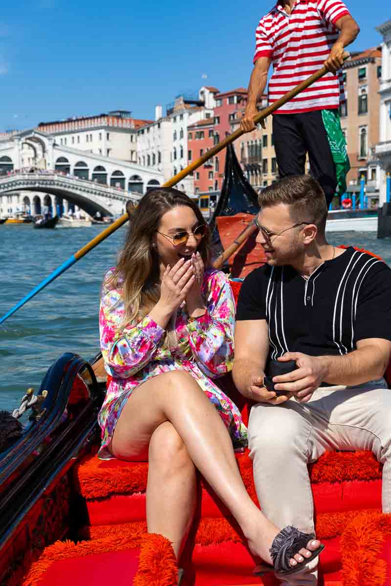 Surprise wedding proposal in Venice candidly photographed on a gondola ride by a proposal photographer