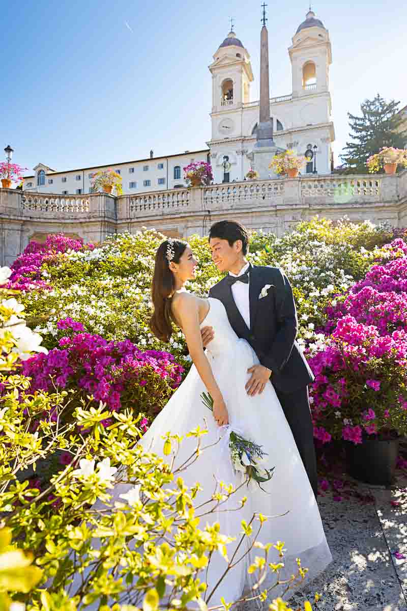 The flowers of the Spanish steps used to take wedding pictures of a couple on a destination wedding in Rome