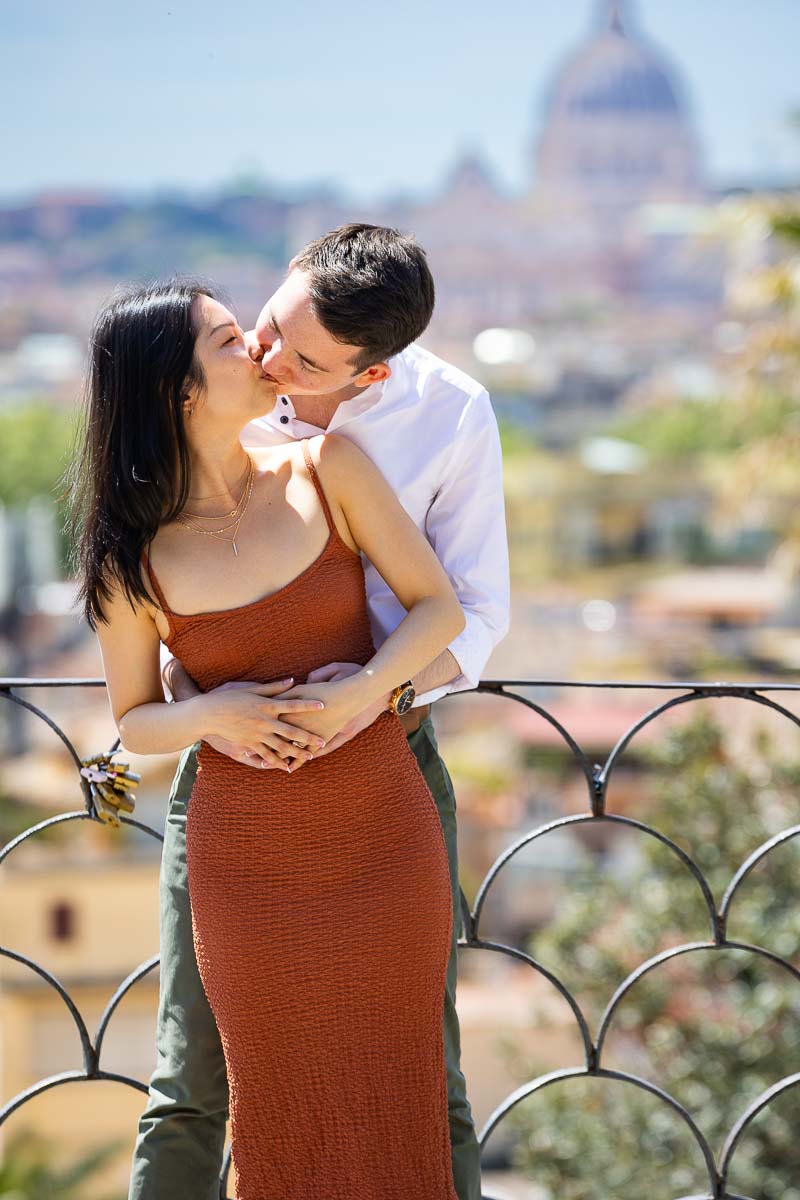 Close up kissing portrait in front of the roman skyline