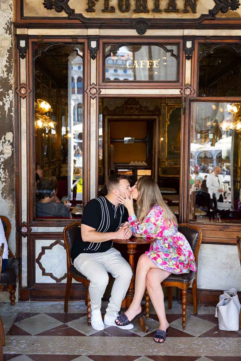 Couple portrait kissing in front of Florian caffè