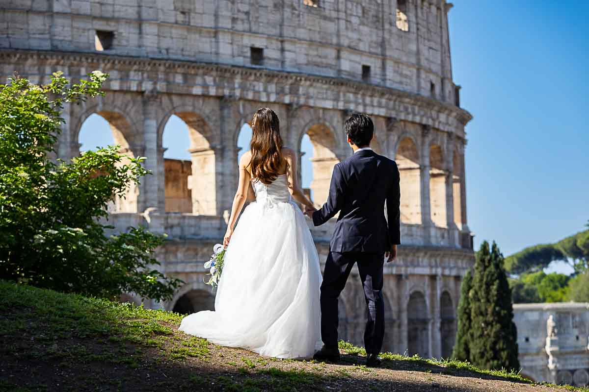 Looking at the Colosseum during pre wedding photos in Rome