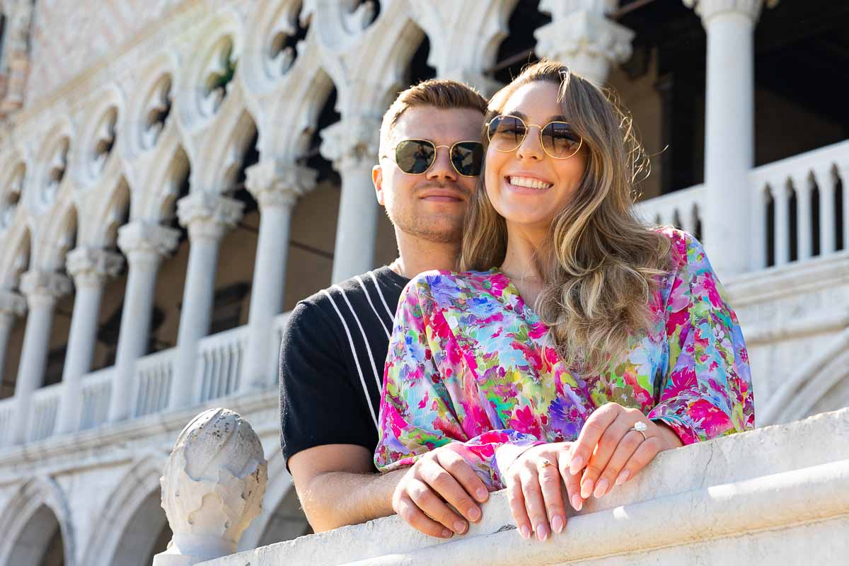 Couple smiling portrait taken in front of Palazzo Ducale in Venice during a photoshoot with professional photographers