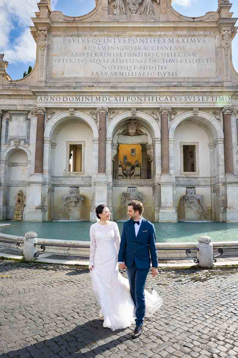 Walking across the street from the Fountain of Acqua Paola also known as Fontanone during a photoshoot in Rome
