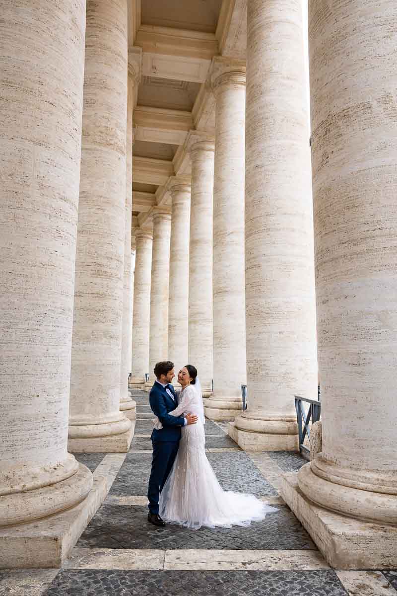 Posed picture taken underneath the columns found in Saint Peter's square in the Vatican found in Rome Italy 