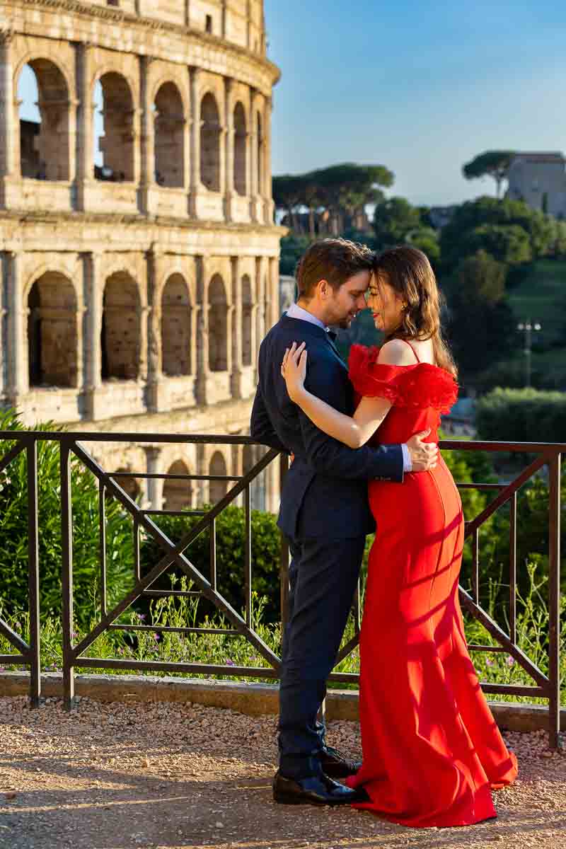 Couple taking formal pictures at the Colosseum in Rome Italy during the golden hour