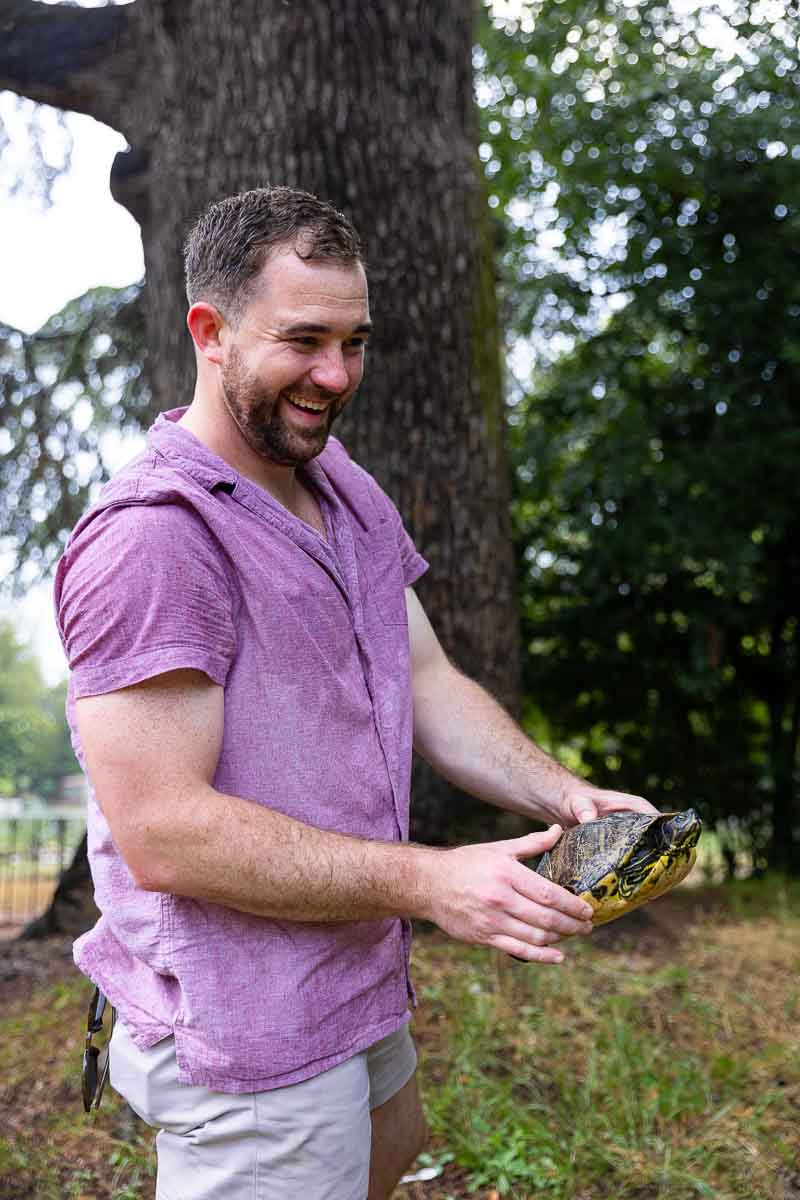 Holding the turtle in hand and putting it in the right direction 