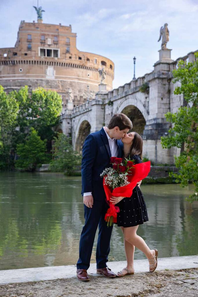 The she said yes moment celebrated with joy and happiness together with a bright red bouquet of long stem red roses