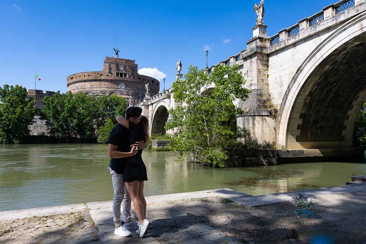 The moment in which she said yes. Couple hugging during a proposal photographer session in Rome
