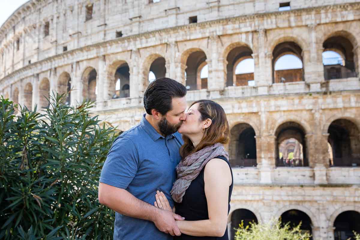 kissing in front of the Roman Colosseum in Rome Italy