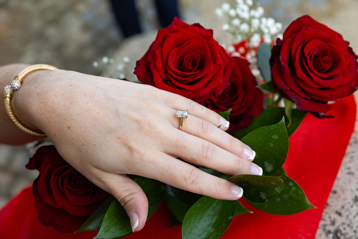 Photo of the engagement ring photographed over red roses during a photoshoot in Rome Italy