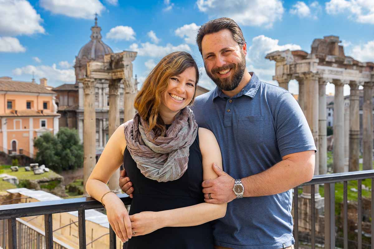 Couple happy portrait taking pictures while visiting Rome image taken in front of the forum