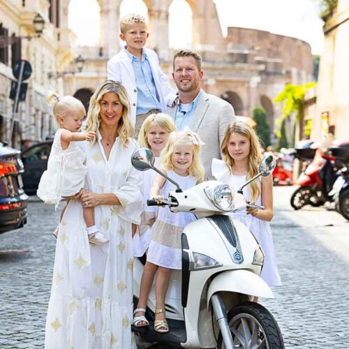 Family photoshoot in Rome Italy photographed on a white piaggio liberty scooter
