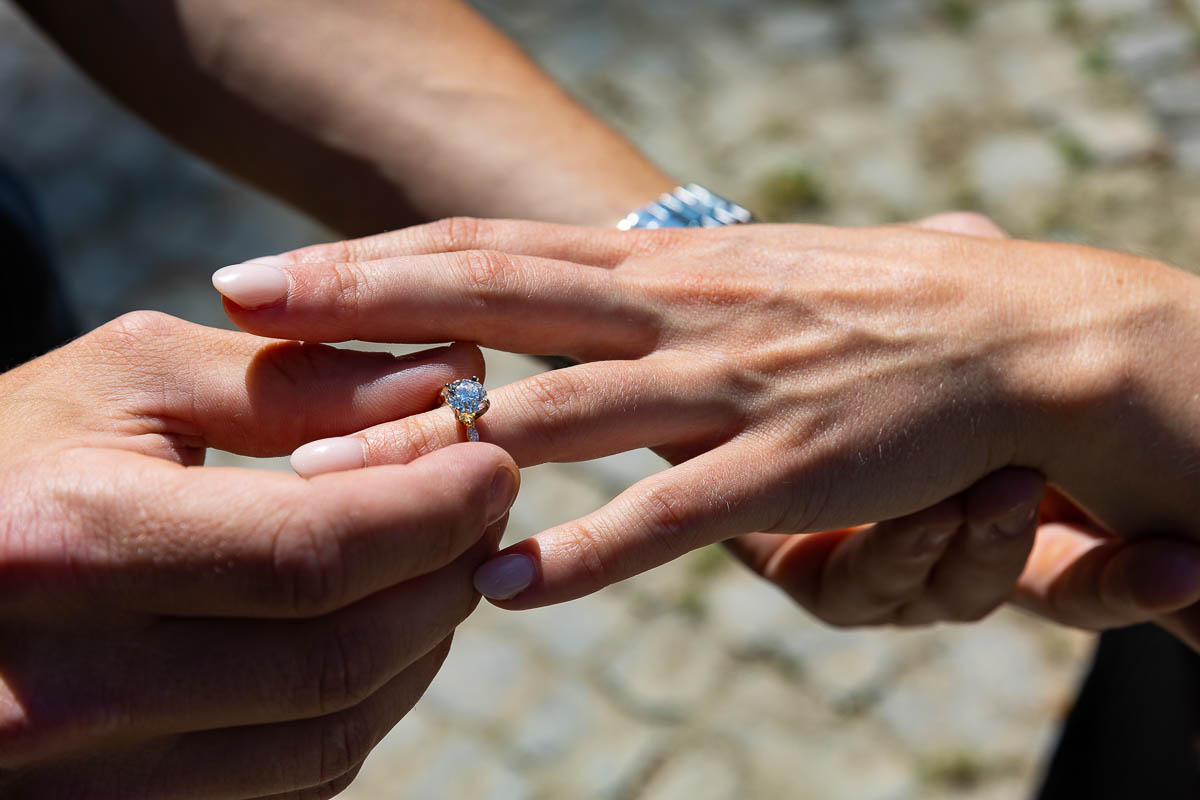 Putting on the engagement ring during a coupe photoshoot in Rome Italy