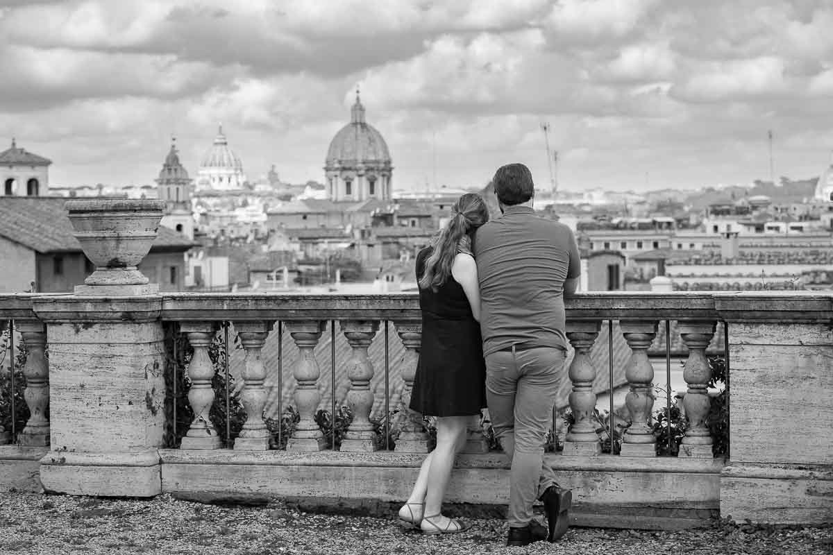 Black and white photoshoot of a couple observing the sweeping view of the city of Rome Italy