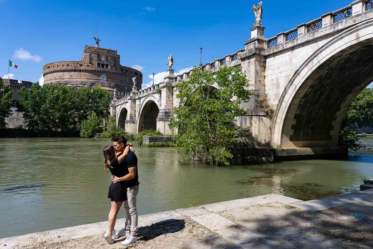 Kissing under the Castel Sant Angelo bridge by the Tiber river bank