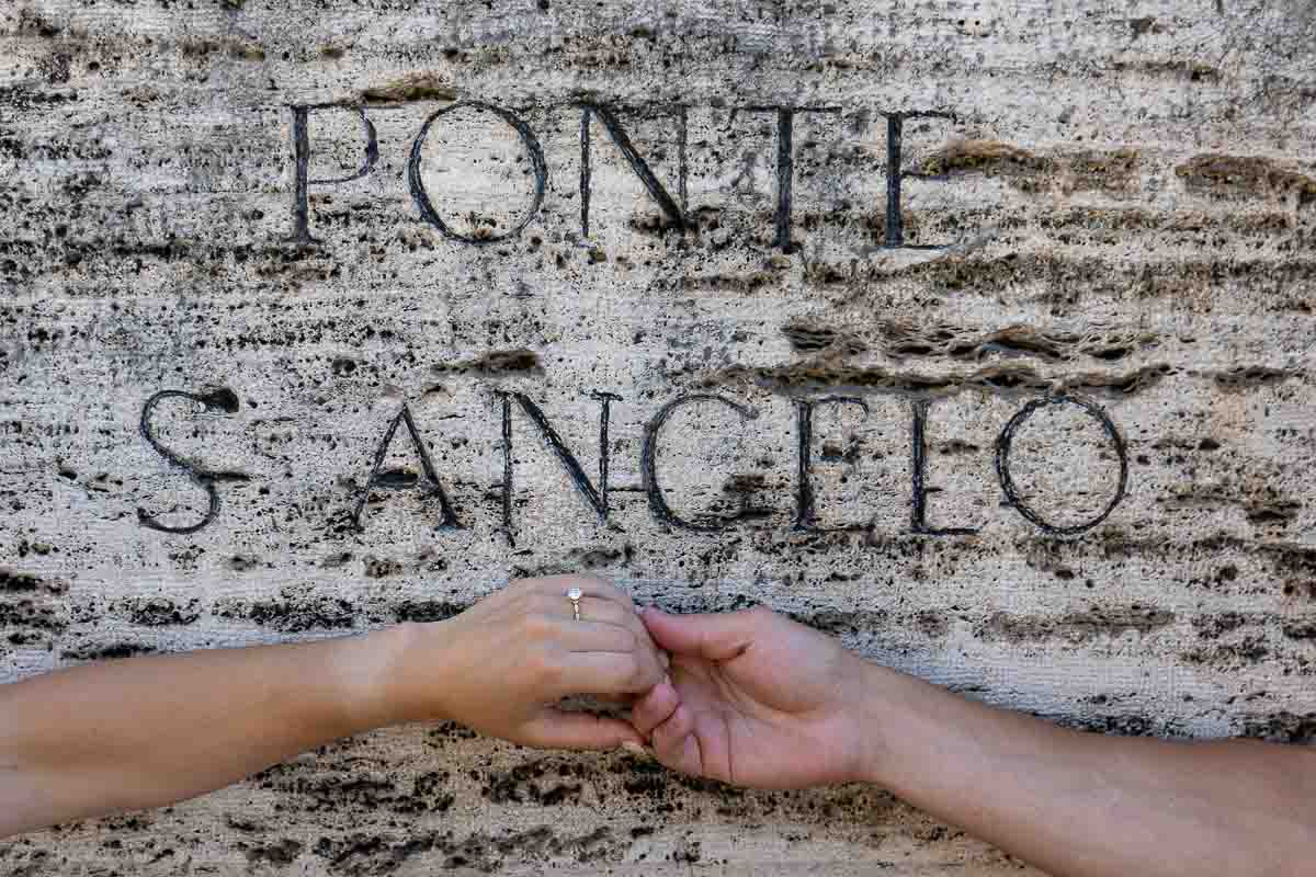 Picture of the engagement ring over the Ponte S.Angelo ancient encryption