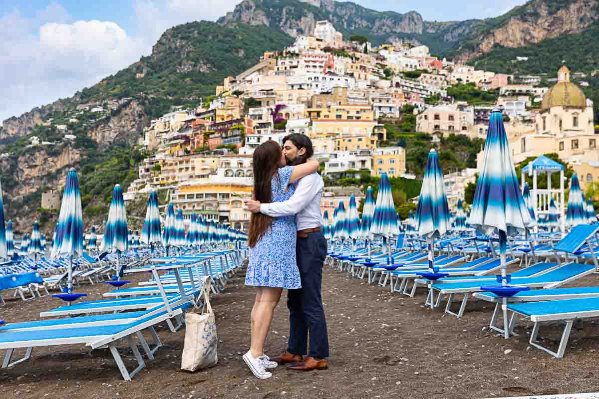 Proposing marriage among typical beach umbrellas found on the beachfront of Positano Italy