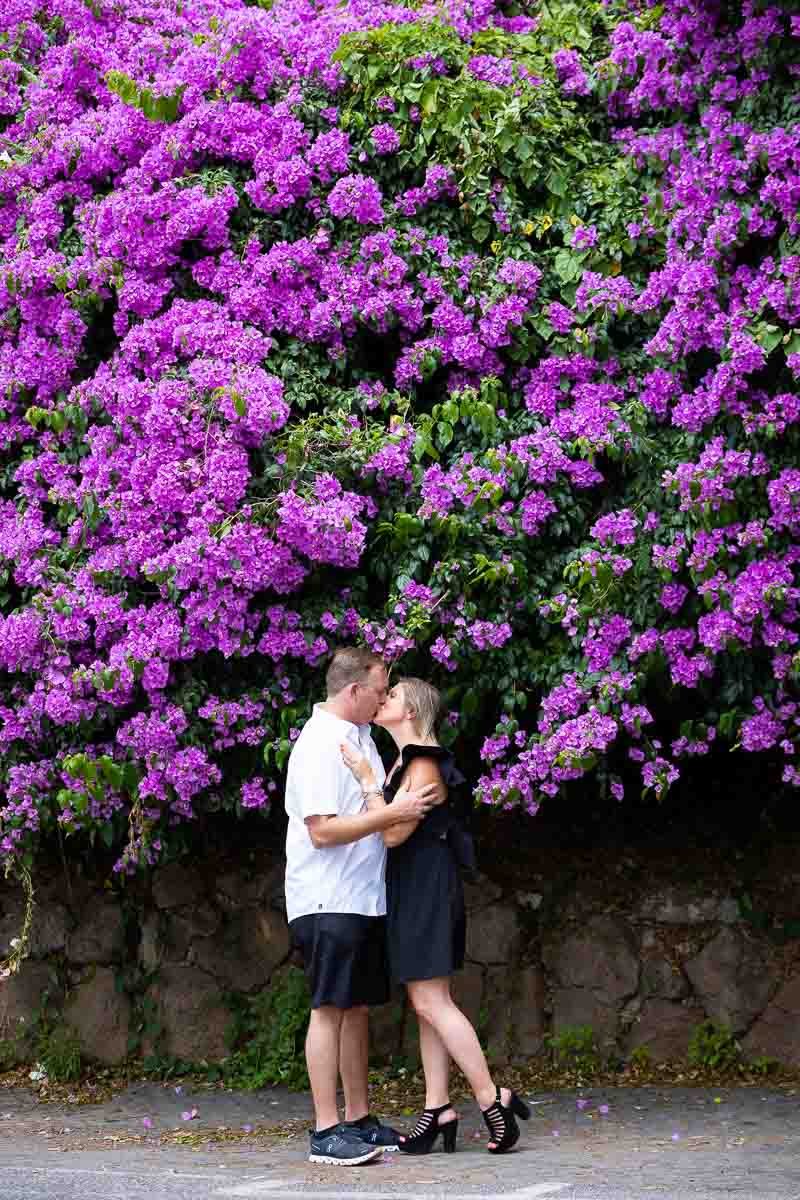 Couple portrait under a beautiful Bougainvillea with fuchsia flowers 