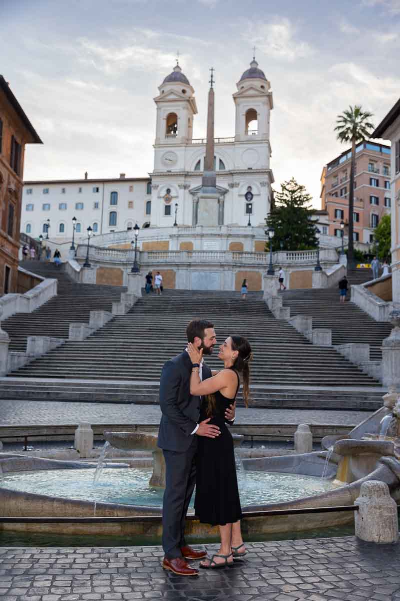 Standing at the bottom of the Spanish steps taking engagement pictures in Rome Italy