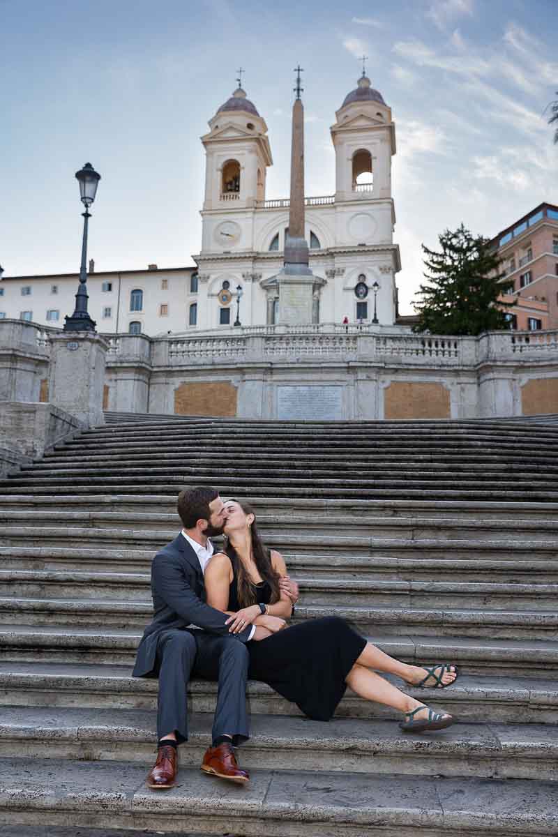 Couple sitting down on the Spanish steps during a photo shoot in Rome