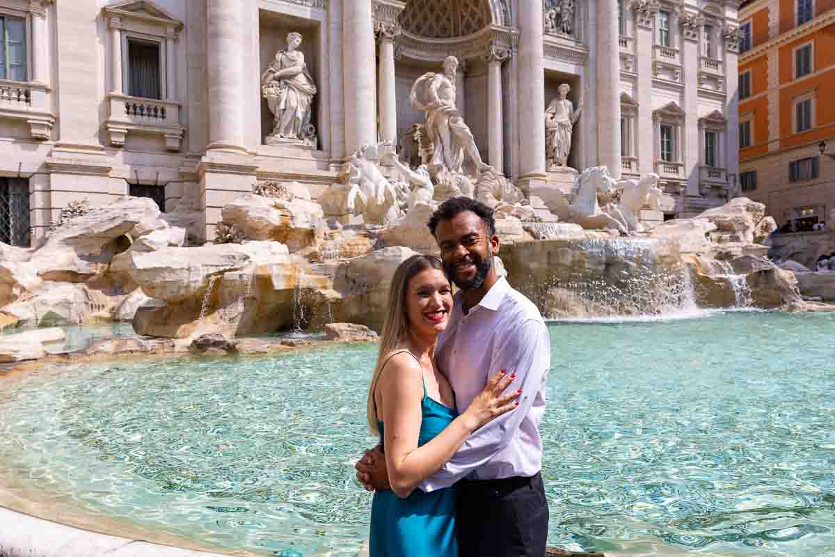 Couple portrait photographed in front of the Trevi water fountain found in Rome Italy 