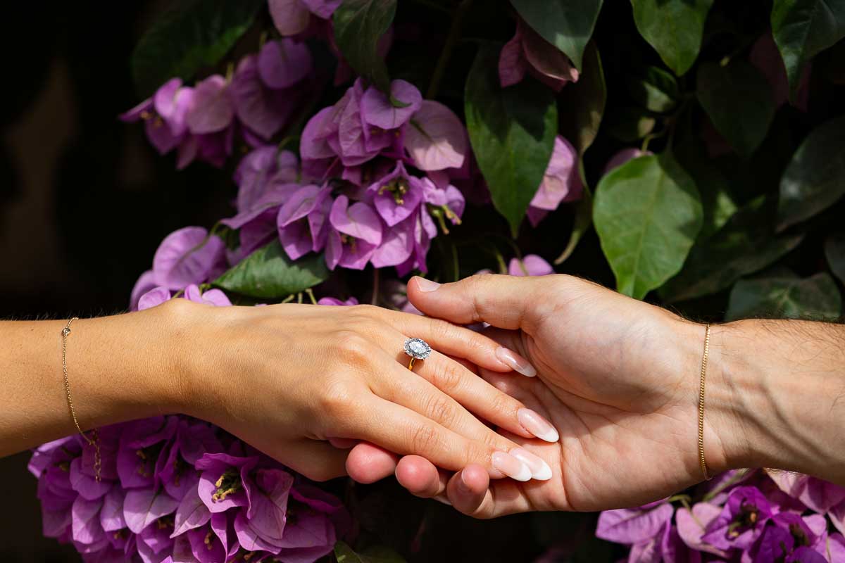 Picture of the Engagement ring photographed up close in front of bouganville fuchsia flowers 