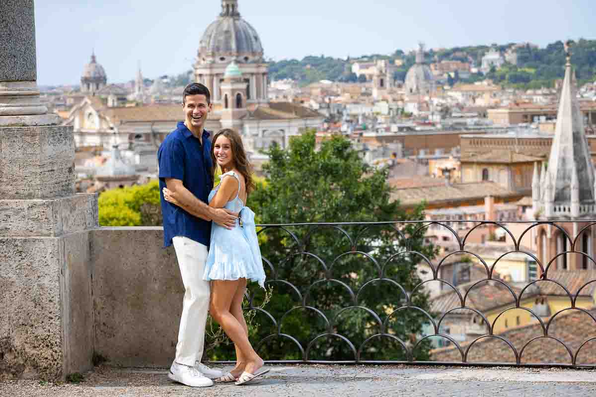 Taking pictures together at the Pincio park terrace outlook overlooking the city of Rome from above