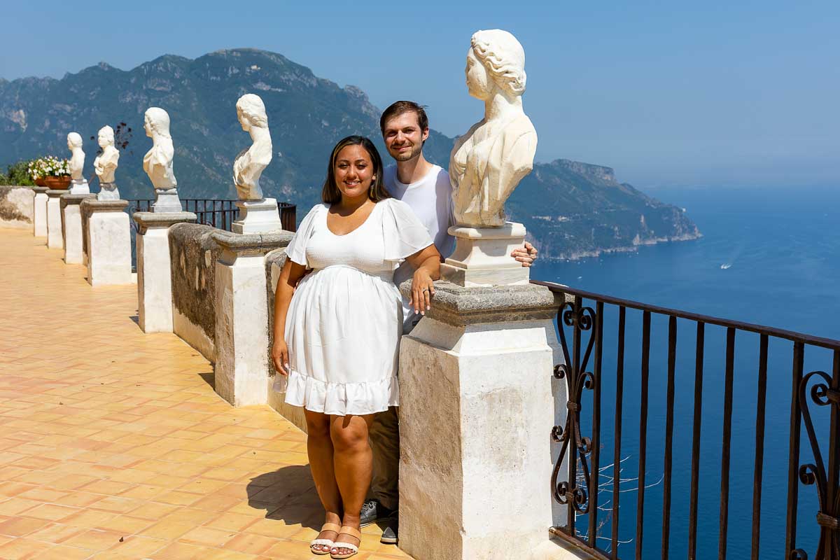 Couple posed next to bust statues on the Infinity terrace