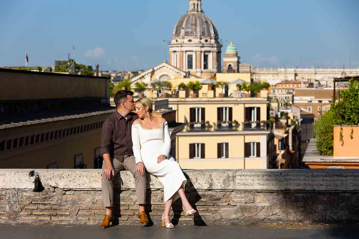 Sitting down on a small wall taking portrait pictures in Rome Italy