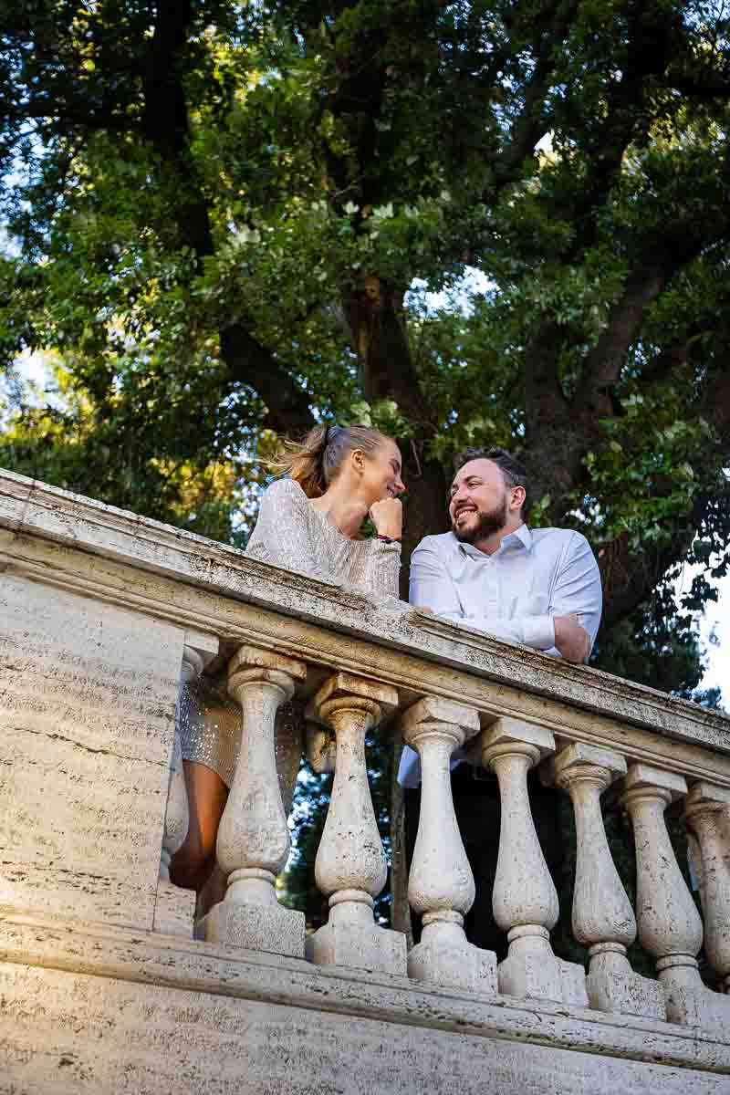 Balconade terrace view of a couple hanging out in Villa Borghese park in Rome Italy
