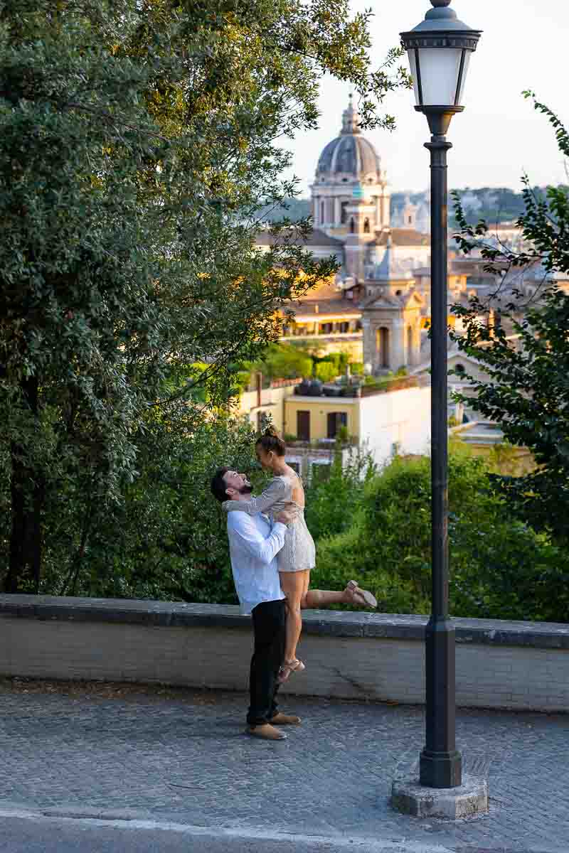 Pick me up image of a couple during a photo session in the roman streets at sundown